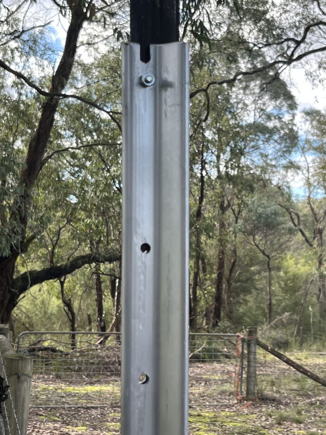 StakeTek fence extension sleeve over a star picket, showing the pre-drilled mounting holes